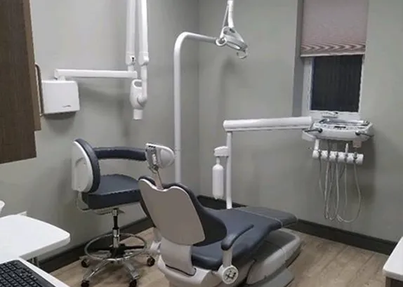 A second treatment room with the chair, overhead light and delivery unit