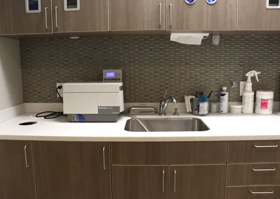 Instrument preparation bay with a MidMark autoclave, sink and supplies